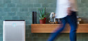 person walking by coway airmega air purifier