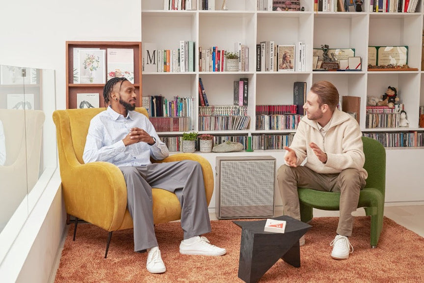Two people using dorm room essentials like an air purifier.
