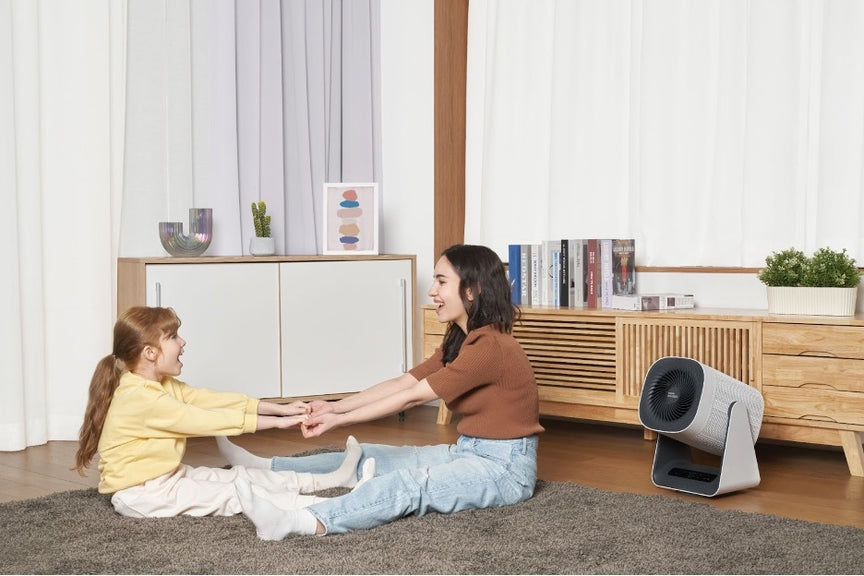 Two people using an AirMega Aim air purifier for dust.
