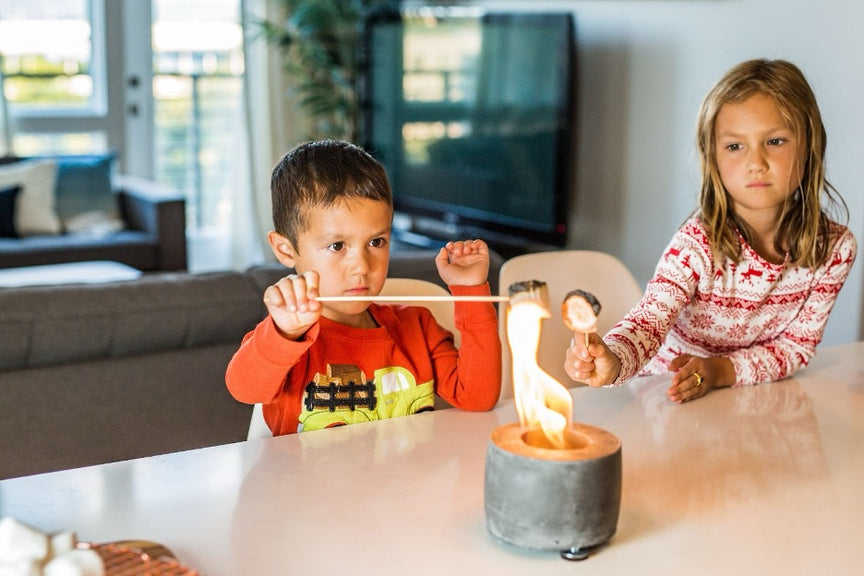 Kids toasting marshmallows on National Marshmallow Toasting Day.