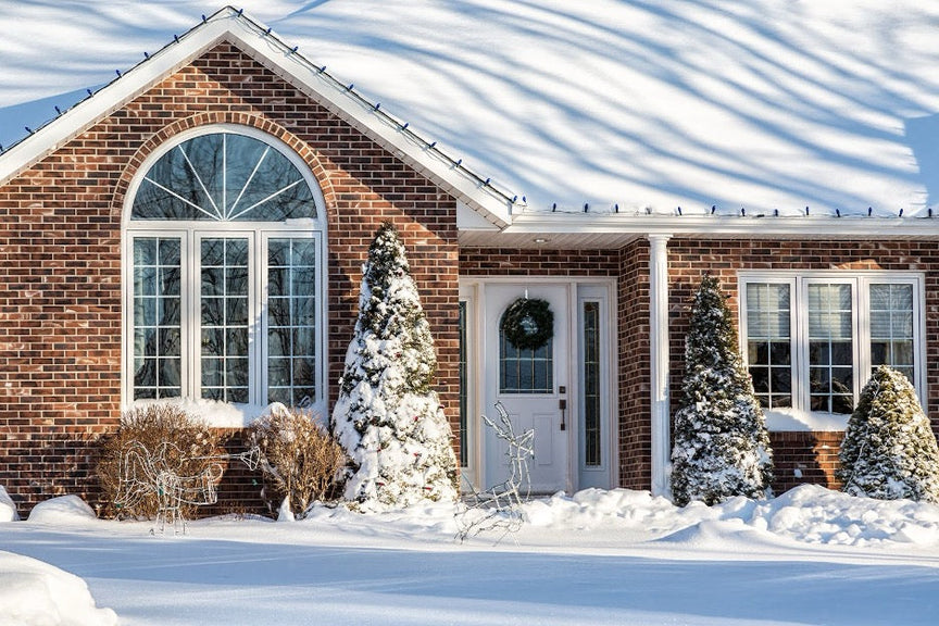 A home in winter covered in snow.