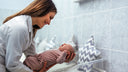 A nurse helping with newborn breathing.