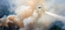 helicopter dropping sand on wildfire