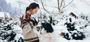 Dog jumping on lady in snow for air out there story