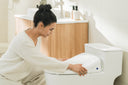 A person installing the Coway Bidetmega 200N.
