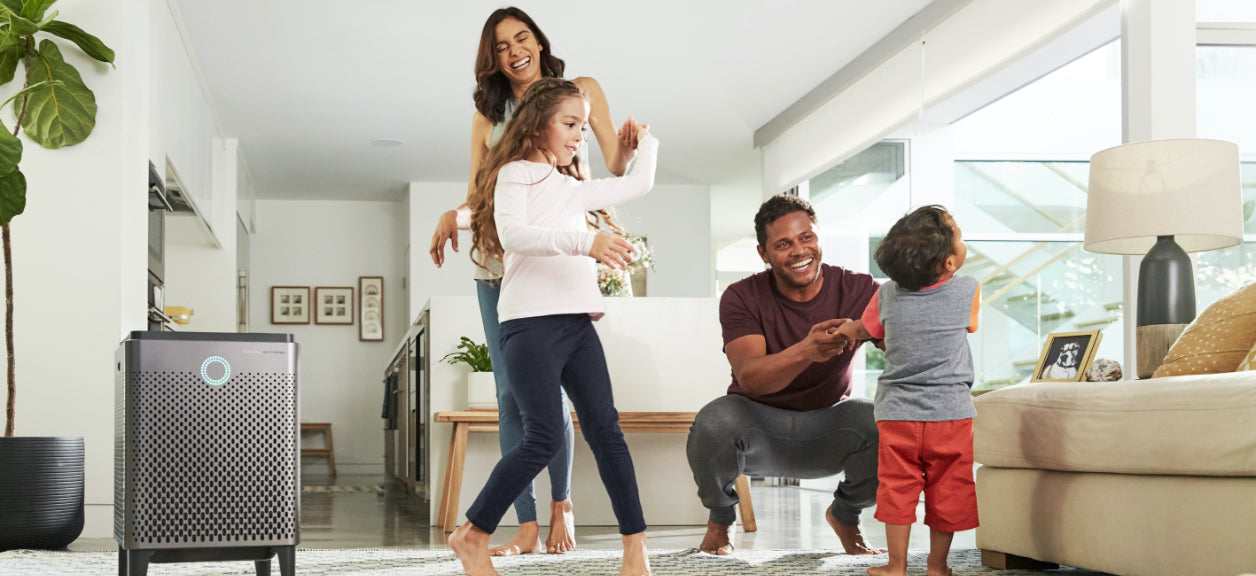 family in room with coway airmega air purifier