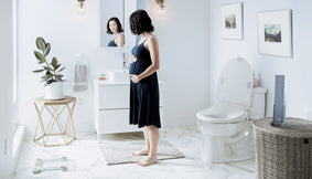 A pregnant mother looking in a mirror.