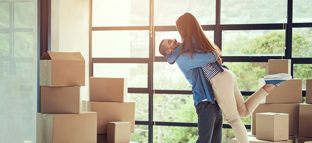 couple hugging next to moving boxes