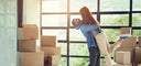 couple hugging next to moving boxes