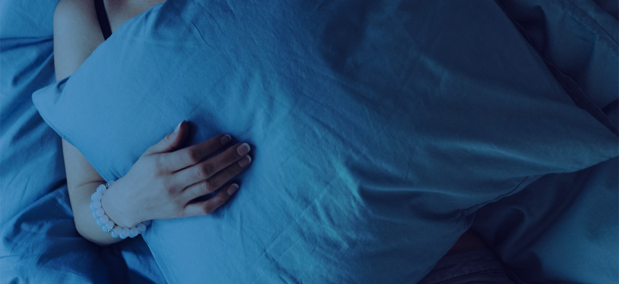 person sleeping holding a pillow