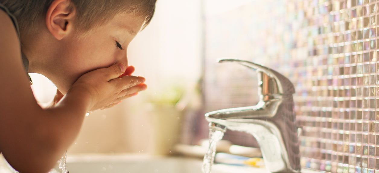 A person drinking from tap water wondering what is the best tap water.