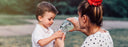 woman filling up childs glass with water