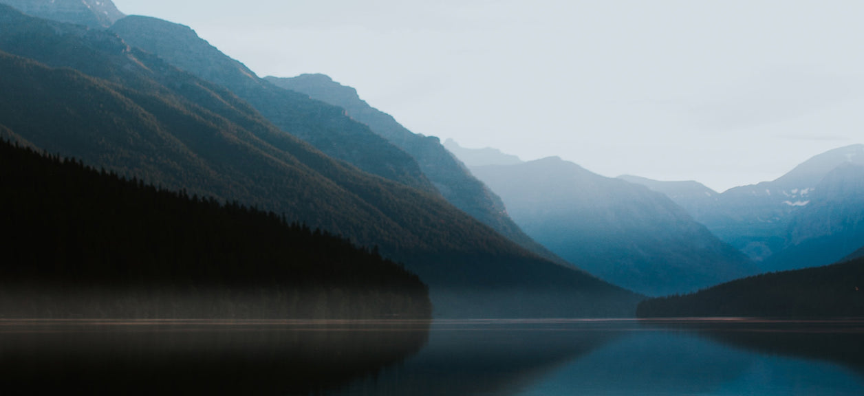 mountains in background of lake