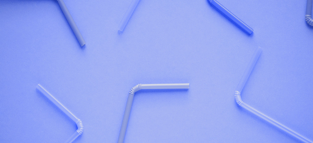 plastic straws on purple background