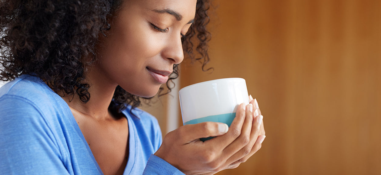 woman smelling coffee