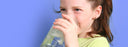 child drinking water from glass