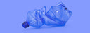 crushed up plastic water bottle on purple background