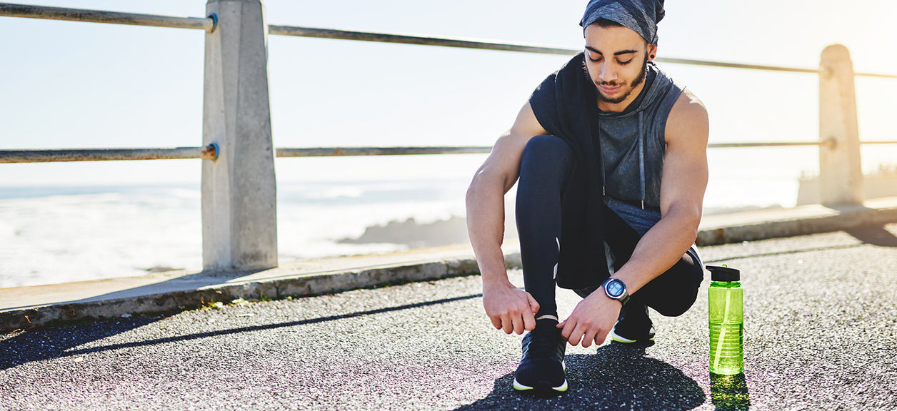 person tying shoes before going for a run