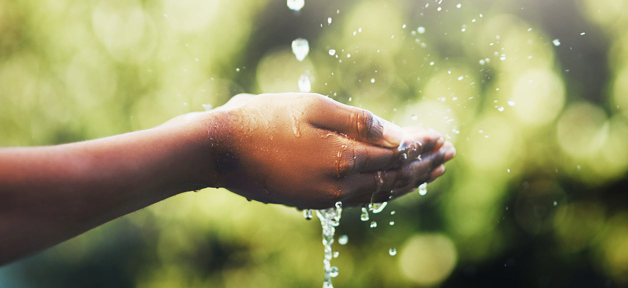 hand cupping falling water