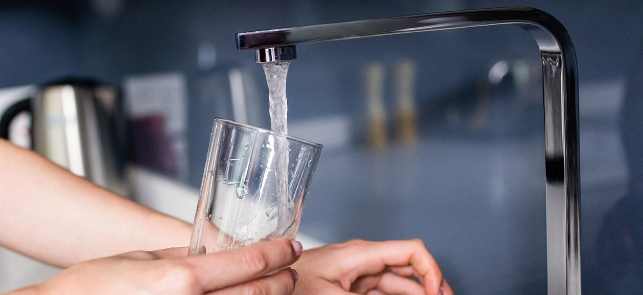 faucet filling glass with water