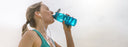 woman drinking from water bottle