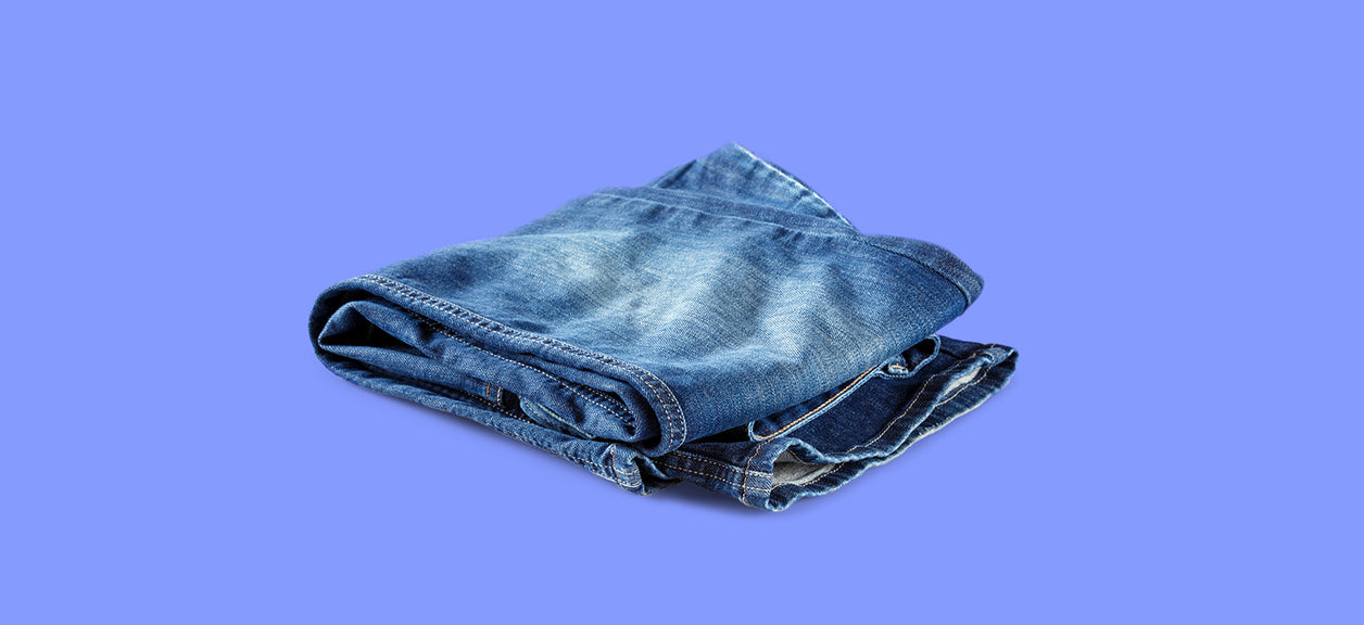 jeans folded on purple background