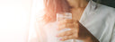 hand holding glass of water