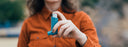 woman holding an inhaler