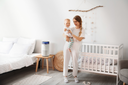 A mother and a baby in a nursery.