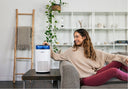 A person turning on an Airmega 100 in a dorm room for better air quality.