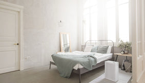 A bedroom with an Airmega 150 in Dove White.