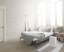 A bedroom with an Airmega 150 in Dove White.