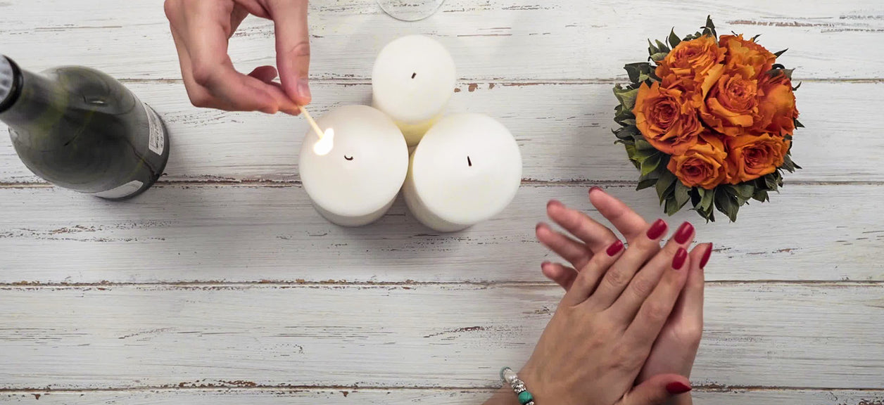 hands lighting a candle