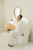 A person on a Bidetmega 200N celebrating Wellness Month.