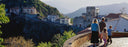 family overlooking houses off a cliff