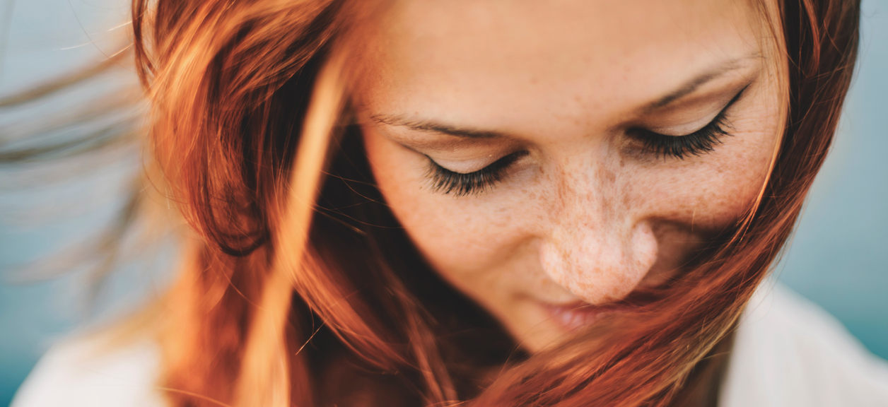 woman looking down, smiling