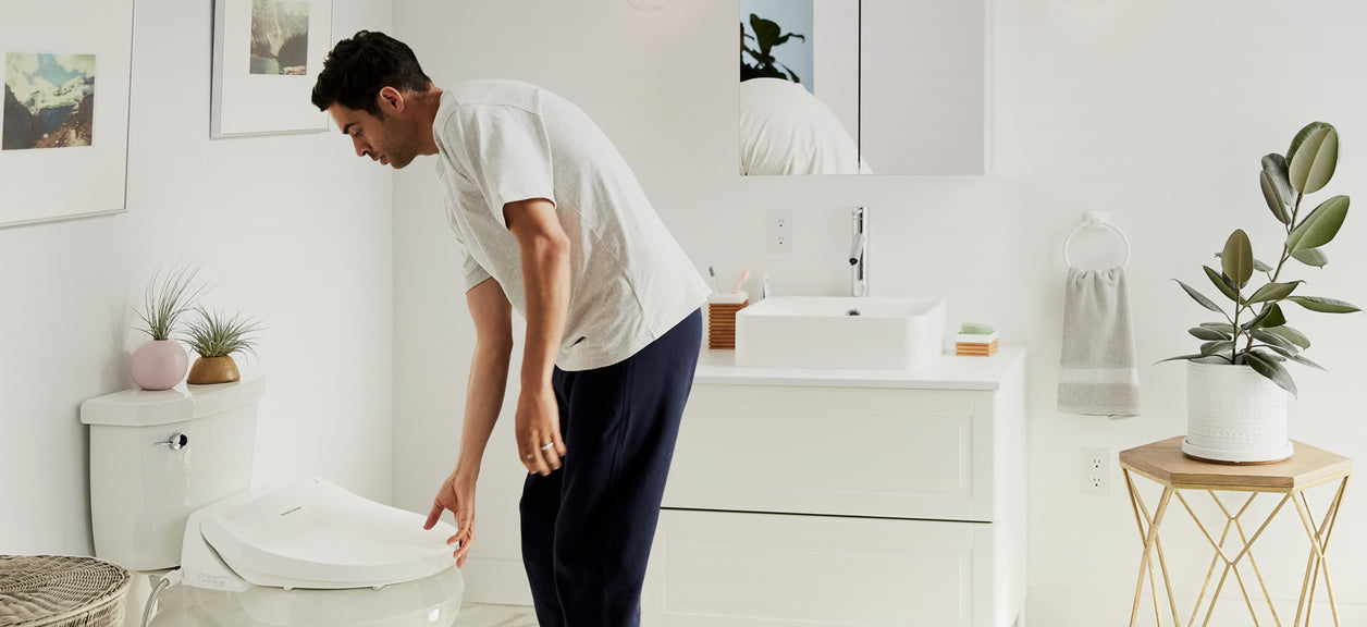 man opening bidet toilet seat