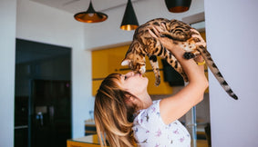 A child holding a cat.