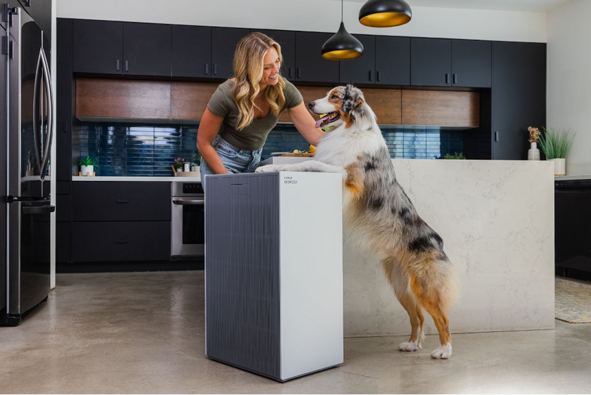A woman with her pet and the Airmega ProX