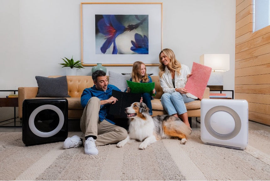 A family and their dog opening an air purifier gift.