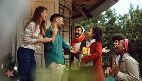 A group entering a home for a holiday party.