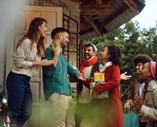A group entering a home for a holiday party.