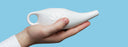 hand holding neti pot