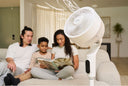 An Airmega Pedestal Fan P50 running next to a family reading a book.