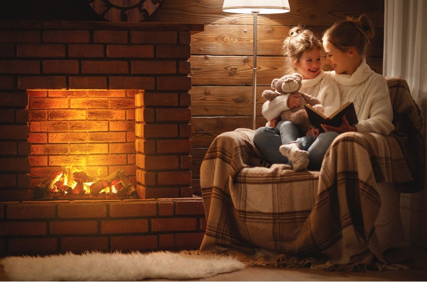 Alt: A parent and child sitting near fireplace smoke.