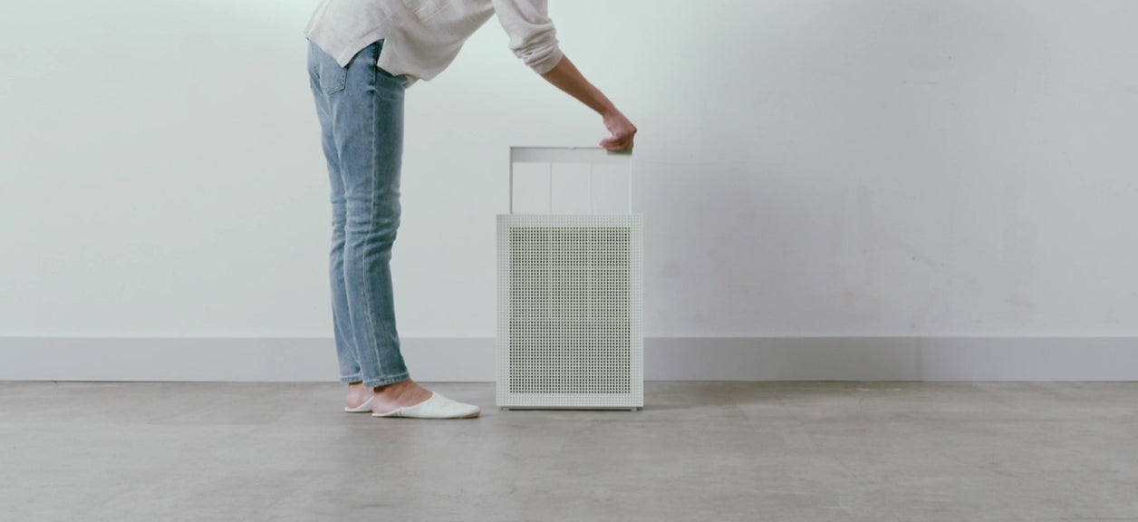  A person using a pre-filter on a Coway air purifier.