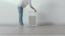  A person using a pre-filter on a Coway air purifier.