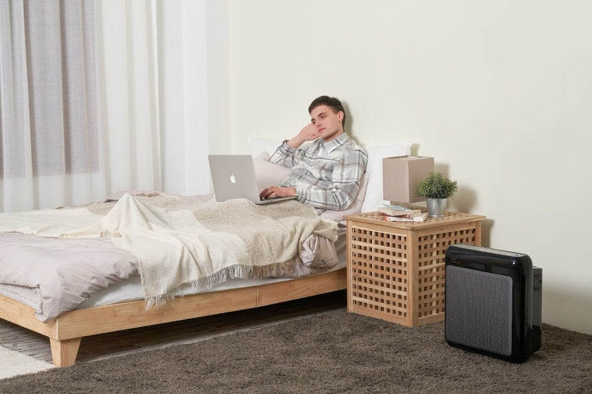 A person sitting next to the Airmega 200M.