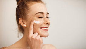 A person applying their skincare products.