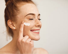 A person applying their skincare products.